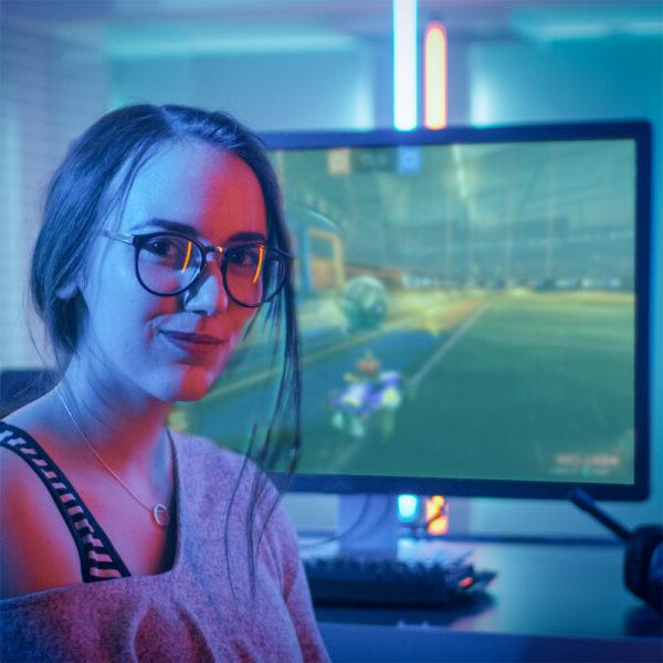 young woman sitting in front of gaming PC